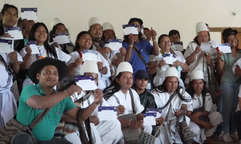 A group of indigenous people showing the certificates granted by the organization my first Bitcoin.