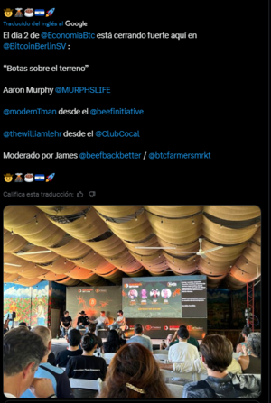 Multiple people gathered in a room watch bitcoiners as they talk about the pioneering digital currency.
