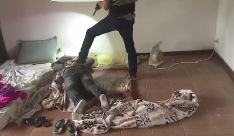 Police subduing kidnapper on the ground.