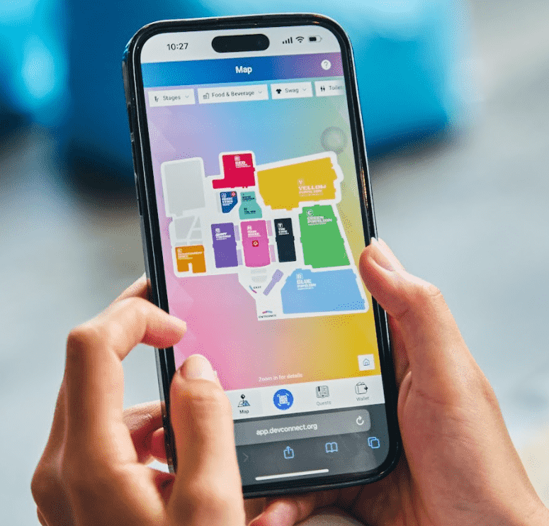 On the screen of a phone you can see an image with the different scenarios of Devconnect Argentina 2025. thanks to the event app.