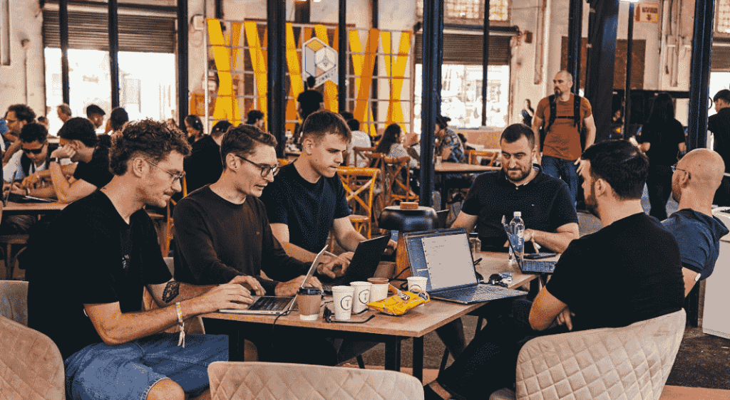 A group of people working with laptops in hand. in collaborative work.