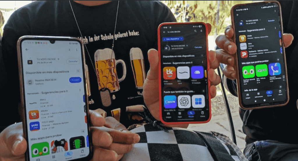 Close-up of several mobile phones shown by people downloading the Tu Voto Decide app in Bolivia.